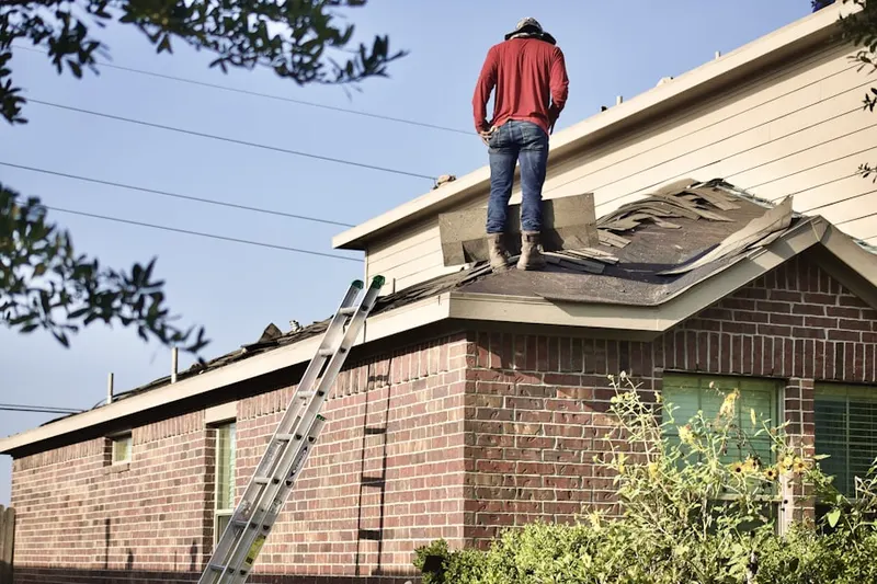 Professional roofer working on a residential roof in Cheesman Park